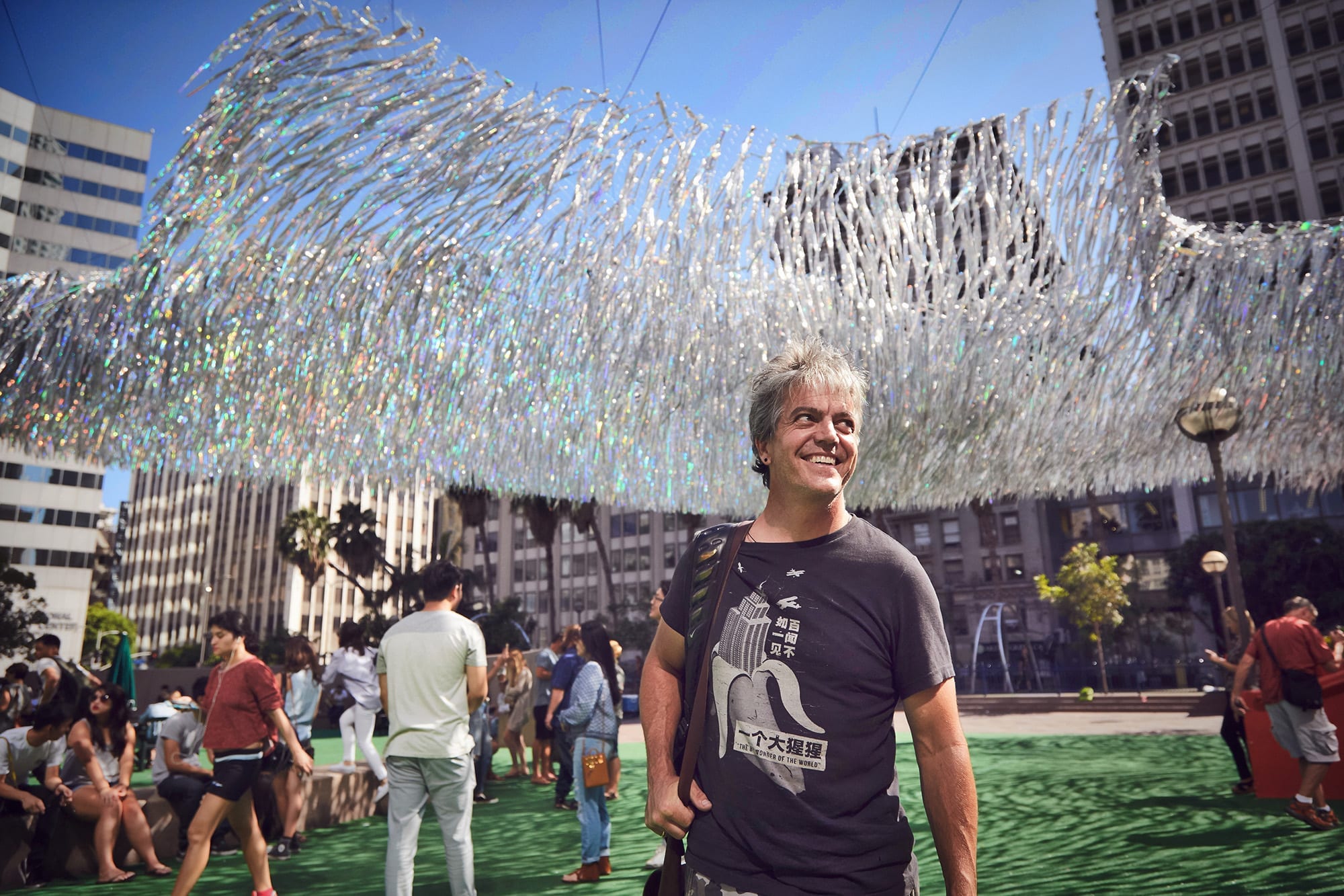 Artist Patrick Shearn of Poetic Kinetics standing under his art installation Liquid Shard at Pershing Square in Downtown Los Angeles
